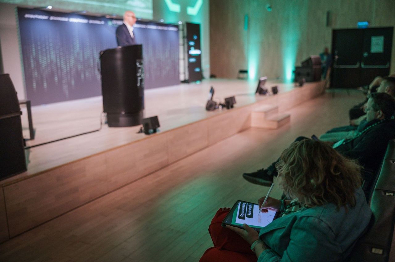 Sylwia Chmielewska rysuje notatkę wizualną na iPadzie podczas prelekcji na CyberTek Tech Festival